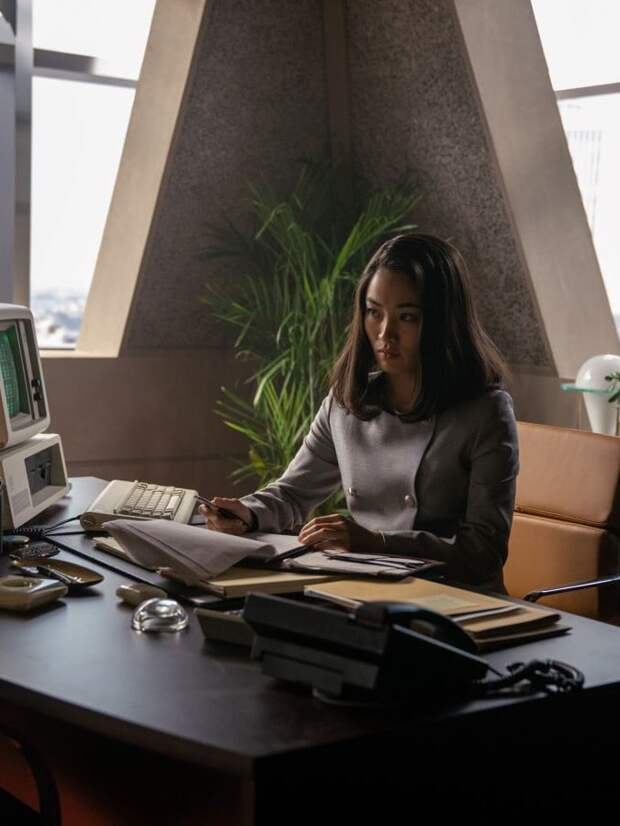 Naomi sits at her desk in her office