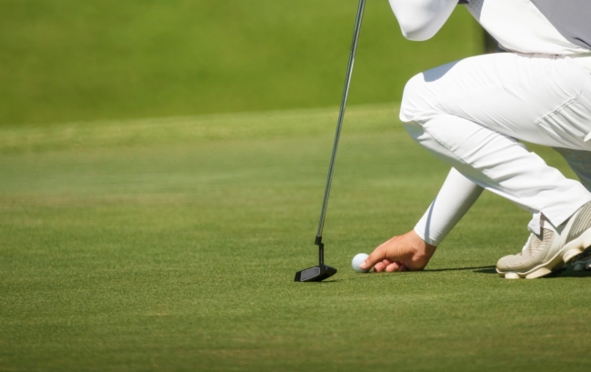 Golfer eyes a putt