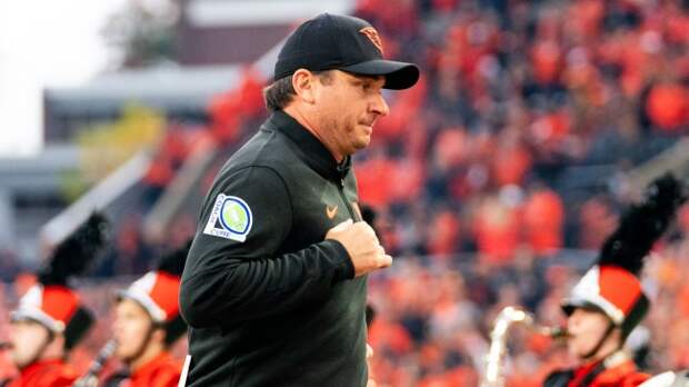 Oregon State head coach Jonathan Smith runs off the field.