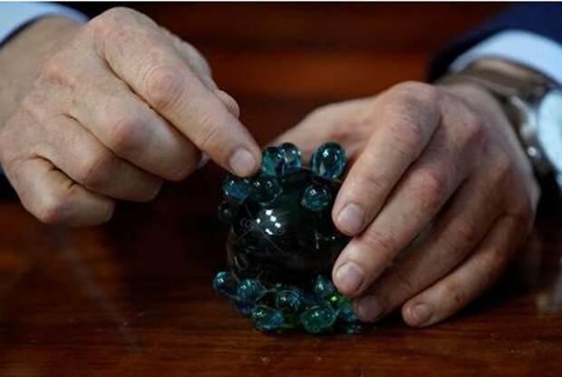 Alexander Gintsburg, director of the Gamaleya National Research Center for Epidemiology and Microbiology, holds a crystal coronavirus figure during an interview with Reuters in Moscow, Russia September 24, 2020. Picture taken September 24, 2020. REUTERS/Tatyana Makeyeva