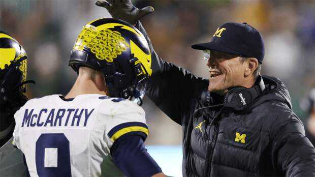 Jim Harbaugh of the Michigan Wolverines congratulates JJ McCarthy