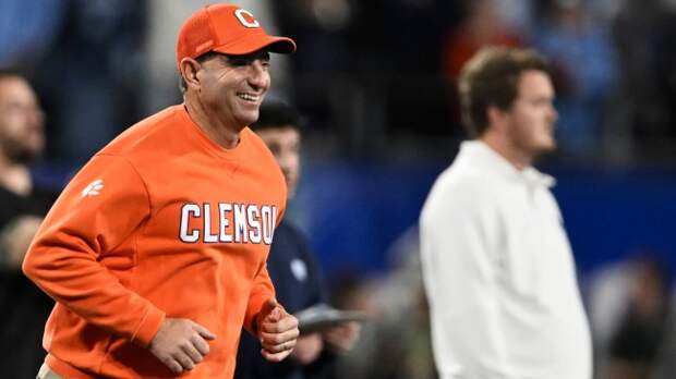 Dabo Swinney runs onto the field during the ACC Championship.