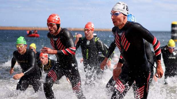 Triathlon swimmers emerging from water