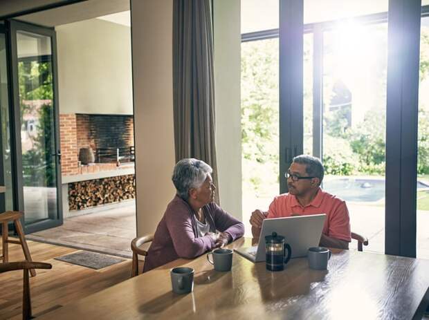 Two people at a laptop.
