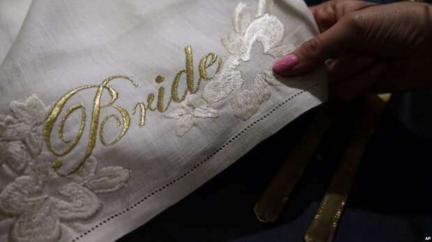 A detail of a napkin with the word 'Bride' embroidered in gold is on display at the Wedding Gallery, in London, March 28, 2018. 