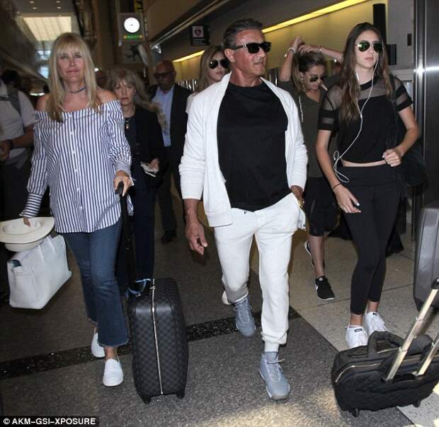 Celebration! The family made their way through the terminal ahead of jetting out for Sylvester's 70th birthday