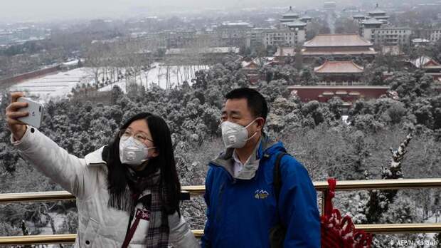 Туристы в защитных масках в Пекине