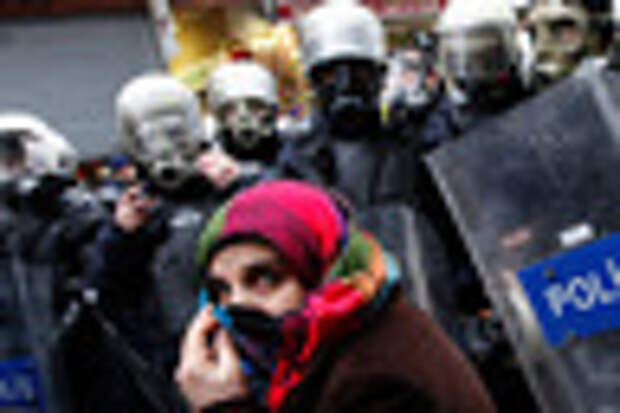 A pro-Kurdish demonstrator covers her face as riot police prevent protestors from marching, at Taksim square in central Istanbul February 15, 2012. Supporters of the pro-Kurdish Peace and Democracy Party (BDP) held a protest to mark the 13th anniversary of the capture of Kurdistan Workers' Party (PKK) leader Abdullah Ocalan. REUTERS/Murad Sezer 