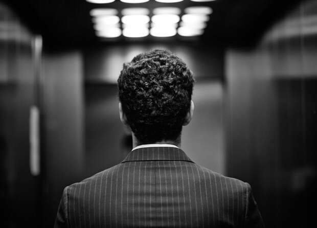 Rear view of young man in suit, black and white image