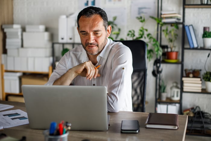 A person at a laptop.