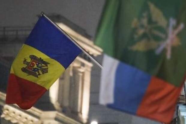 The state flag of Moldova (L) flies outside the country's embassy in central Moscow, Russia December 18, 2017. REUTERS/Maxim Shemetov
