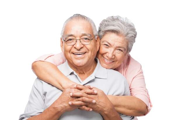 Two smiling people embracing.