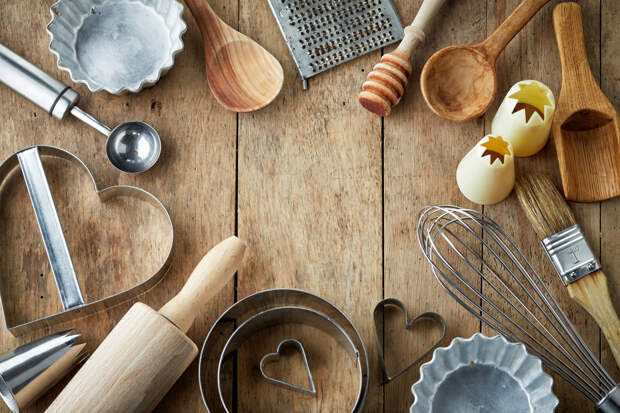 various kitchen utensils on wooden table