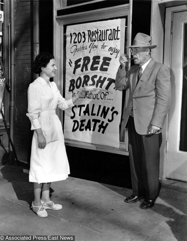 Waitress Eileen Keenan, of Ballinrobi, Ireland, gives a sample of Borsht, a red beet Russian soup, to E.C. Carpenter of Cabin John, Md., outside 1203 Restaurant in Washignton, D.C., on March 6, 1953. The sign outside the restaurant advertises the free Borsht in celebration of Stalin's death. (AP Photo)