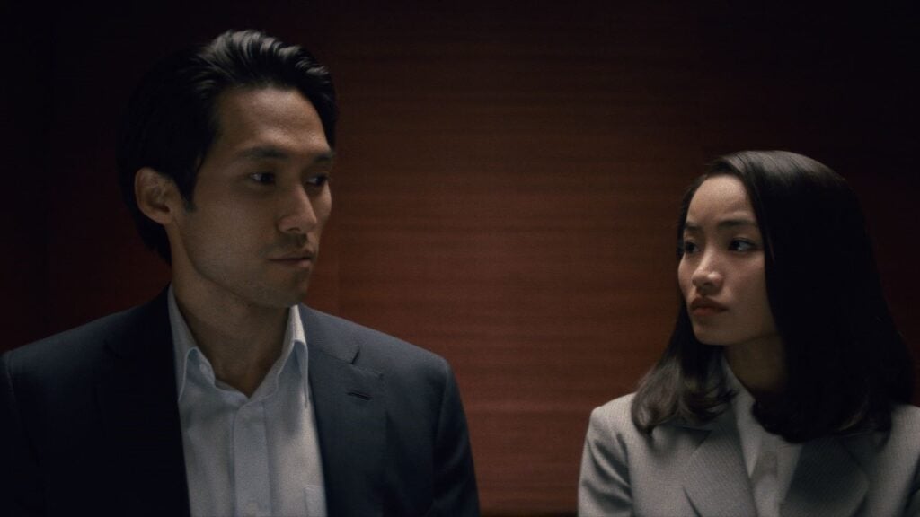 Horizontal shot of Solomon and Naomi in elevator