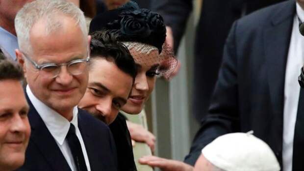 Katy Perry, top, and Orlando Bloom, center, look at Pope Francis greeting people at the end of an audience for the participants in the 