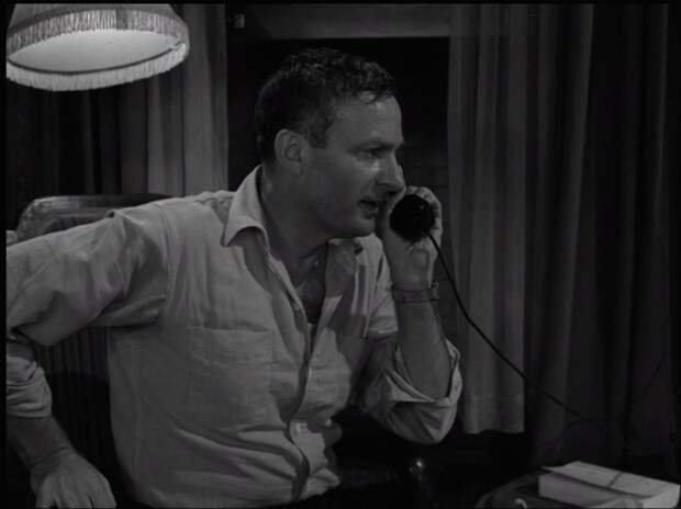 A nervous man making a phone call on The Twilight Zone