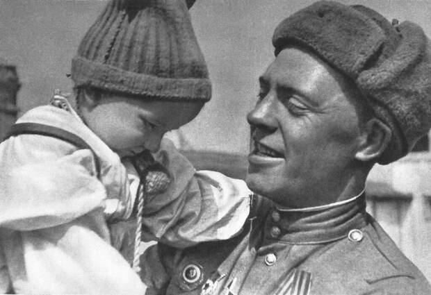 Советский солдат с чешским ребенком на руках. Прага, Чехословакия. Май 1945