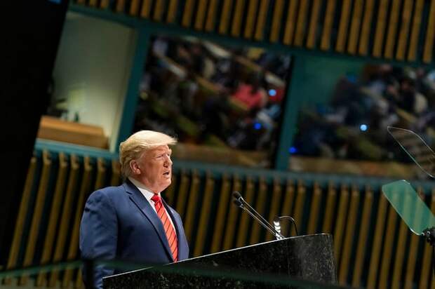 Donald Trump speaking at a podium.