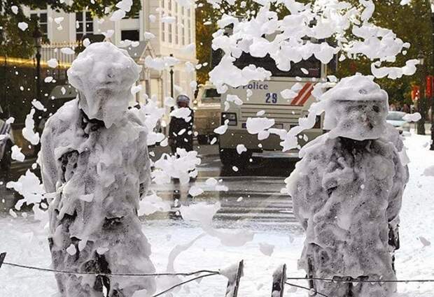 Belgian riot police stand as they are covered with foam sprayed by Belgian firefighters during a protest for better work conditions in central Brussels October 7, 2013.        REUTERS/Yves Herman (BELGIUM - Tags: BUSINESS EMPLOYMENT CIVIL UNREST POLITICS TPX IMAGES OF THE DAY)