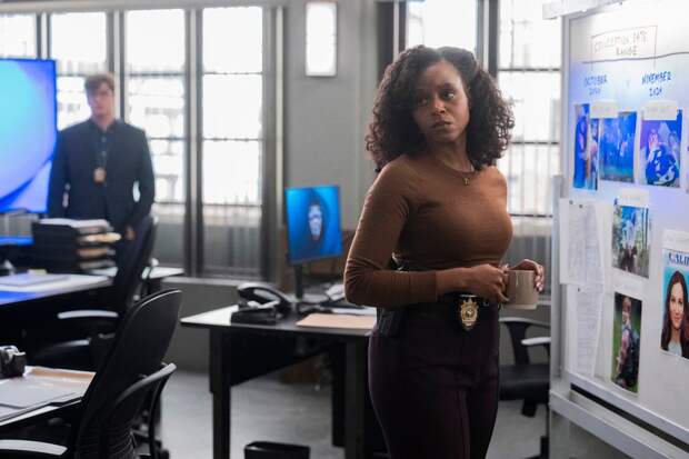 Curry standing by the whiteboard on Law & Order: SVU Season 26 Episode 16