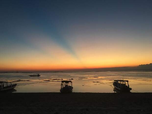 An Indonesian Sunset With The Shadows Of Two Volcanoes