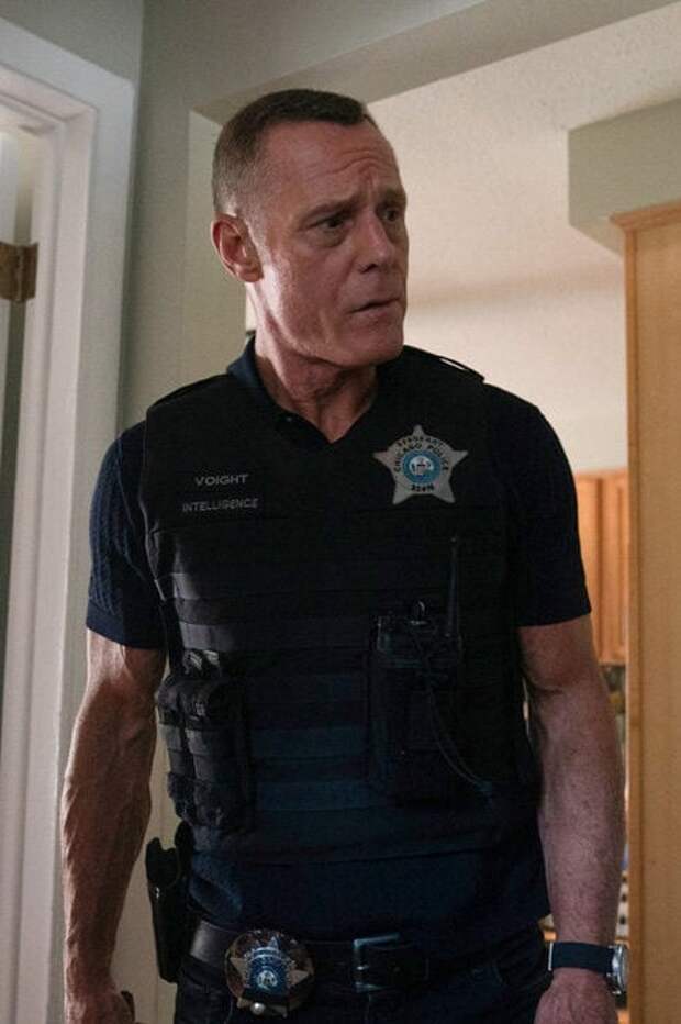 Voight surveys a scene of an armed robbery.