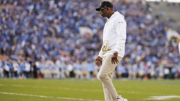 Deion Sanders walks the sidelines during a Colorado football game.
