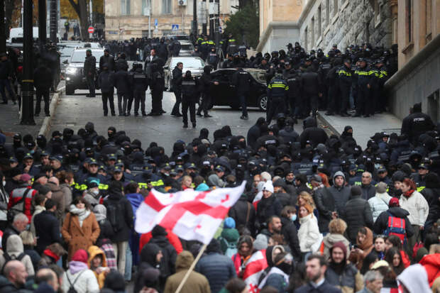 Митингующие в Тбилиси начали кидать камни и стучать по ограждению