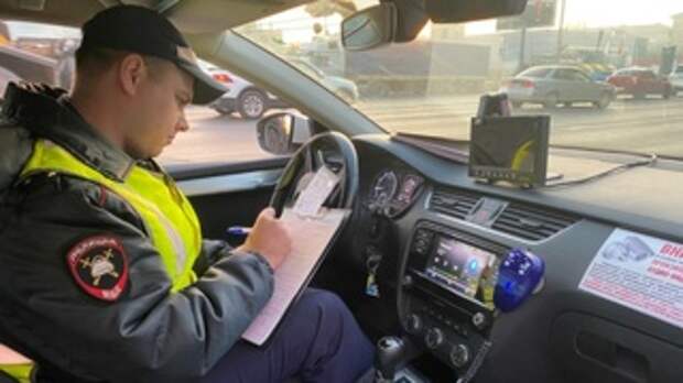 Сотрудник ГИБДД оформляет протокол. Фото: Ирина Киселева / amic.ru