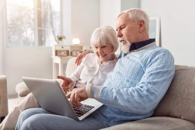 Two people looking at a computer.