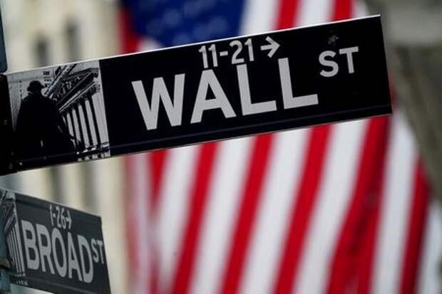 FILE PHOTO: A Wall Street sign outside the New York Stock Exchange in New York City, New York, U.S., October 2, 2020. REUTERS/Carlo Allegri/File Photo