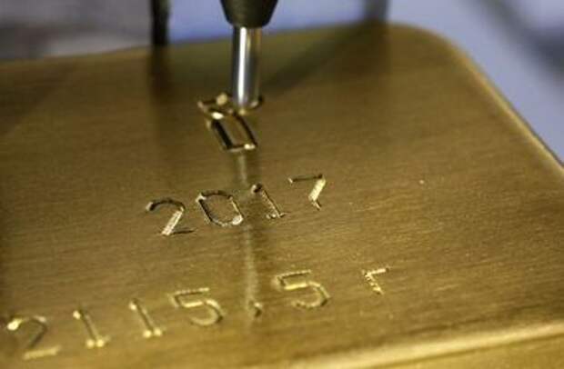 A machine engraves information on an ingot of 99.99% pure gold at the Krastsvetmet non-ferrous metals plant in the Siberian city of Krasnoyarsk, Russia September 22, 2017. REUTERS/Ilya Naymushin/File Photo