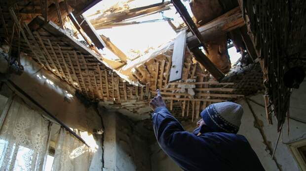 42-летний житель Донецка демонстрирует состояние своего дома на улице Дружбы, в крышу которого попал снаряд - РИА Новости, 1920, 28.10.2021