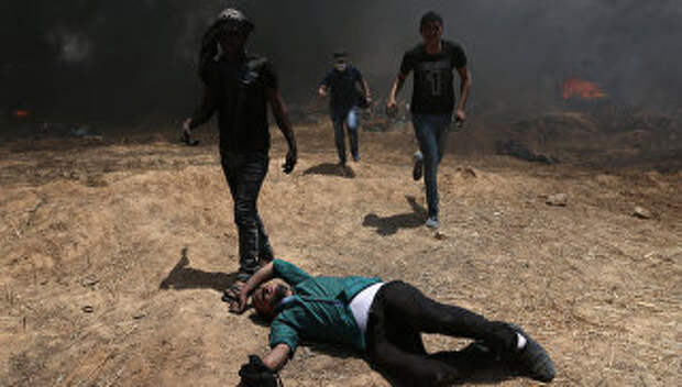 Столкновения палестинцев и израильских военных на границе сектора Газа с Израилем. 14 мая 2018