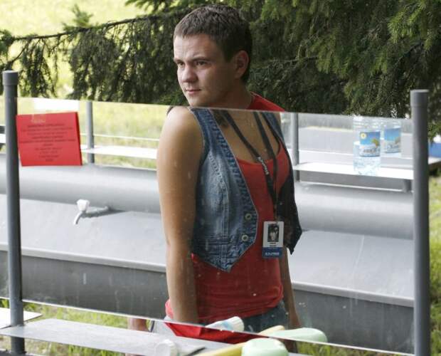 A woman (reflected in the mirror) and a man stand at a washstand at a camp, The Territory of the Initiative Youth "Biryusa", on the banks of the Yenisei river in the Siberian Taiga, some 37 miles south of Russian city of Krasnoyarsk on July 28, 2012. (REUTERS / Ilya Naymushin)