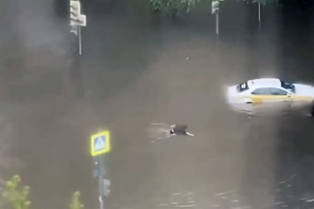 Появилось видео, как в Москве мужчине пришлось пересечь вплавь затопленную дорогу