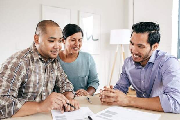 Mortgage lender goes over documents with couple.