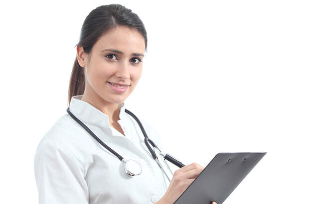 Beautiful nurse smiling and taking notes