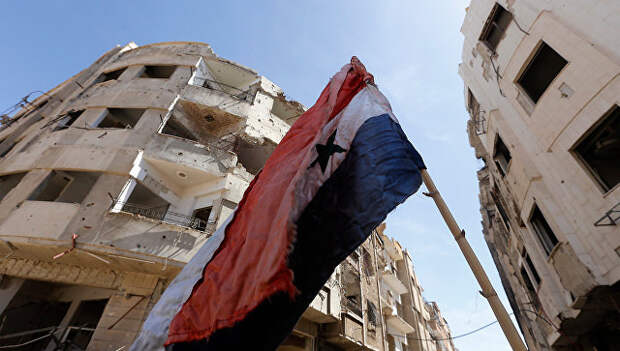 Сирийский флаг на разрушенной улице в Восточной Гуте. архивное фото