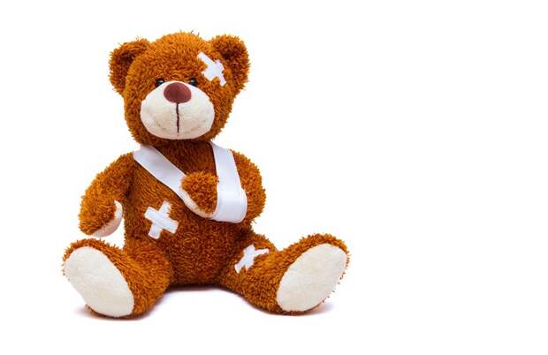 Teddy bear in a sling with bandages