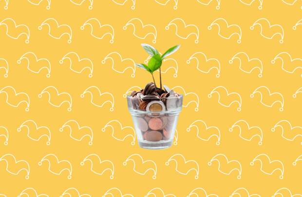 A class pot filled with coins and a sprout growing