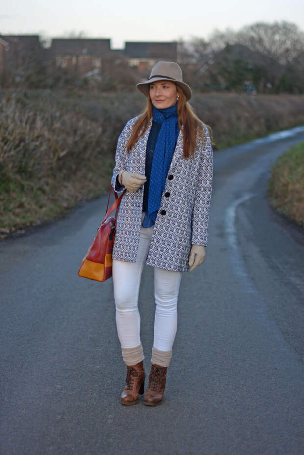 Blue tapestry coat, taupe fedora, white skinny jeans