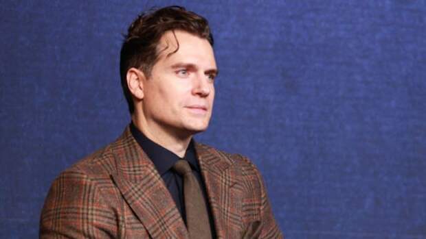henry cavill in a brown suit