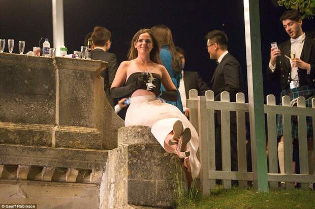 Don't look down! One guest finds a quiet spot to enjoy a glass of champagne as the Monday night party roars on