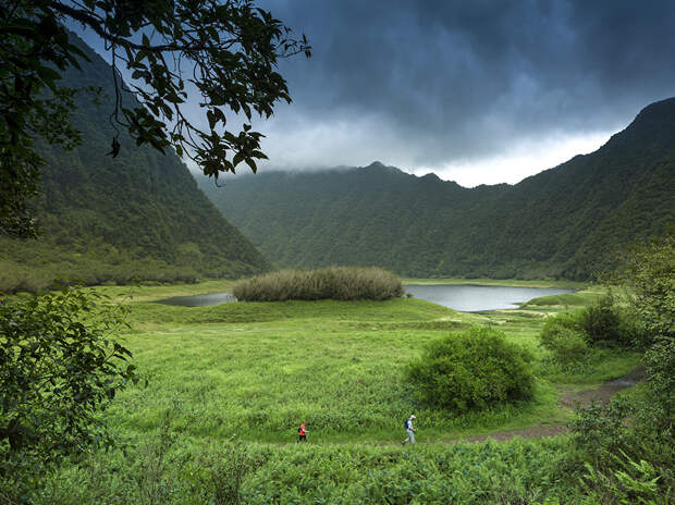 02 Dec 2013, St.-Benoit --- France, Reunion Island, Parc National de la Reunion (National Park of la Reunion), listed as World Heritage by UNESCO, Saint Benoit, Grand Etang, natural landscape of a lake surrounded by mountains under a stormy sky --- Image by © SPANI Arnaud/Hemis/Corbis