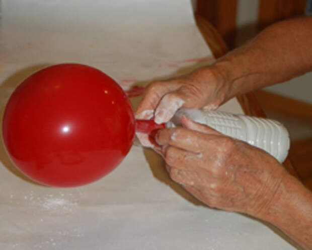 putting the balloon on the bottle