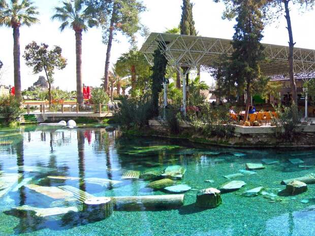 the-sacred-pool-in-pamukkale-turkey-has-submerged-pieces-of-original-marble-columns-from-the-ancient-roman-city-of-hierapolis-the-water-is-said-to-be-rich-in-minerals-that-provide-natural-restorative-powers