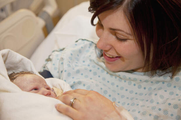 mother holding newborn baby daughter