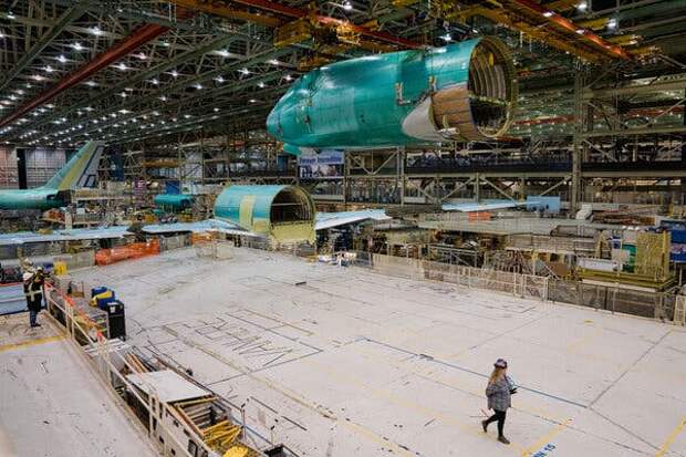 Sections of the 747 plane at Boeing’s factory. The front of the plane is hanging from the ceiling in the foreground.
